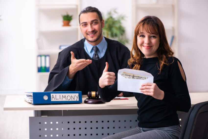 Lawyer assisting a woman with alimony payment and legal paperwork in an office