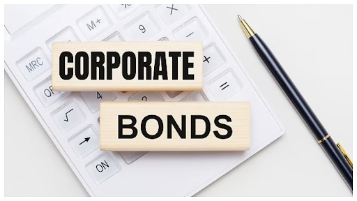 Corporate bonds text blocks placed on a calculator beside a pen representing business and investment finance